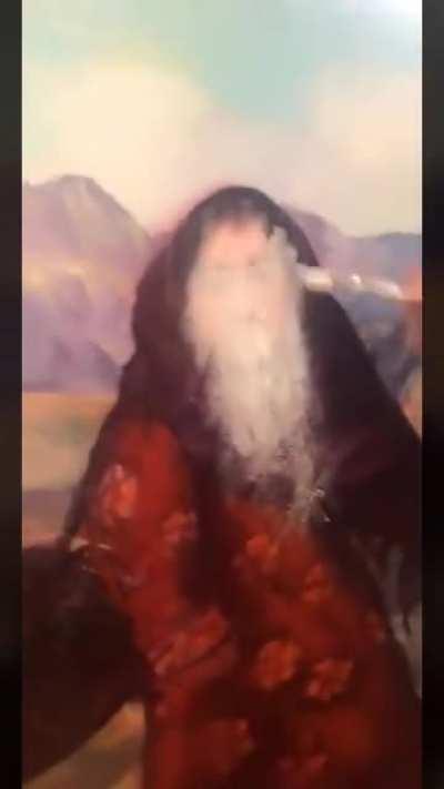 A muslim artist scribbles on a face from his previous art after he was convinced that drawing real life beings is forbidden in islam. Religions not only kill people but they kill arts too.