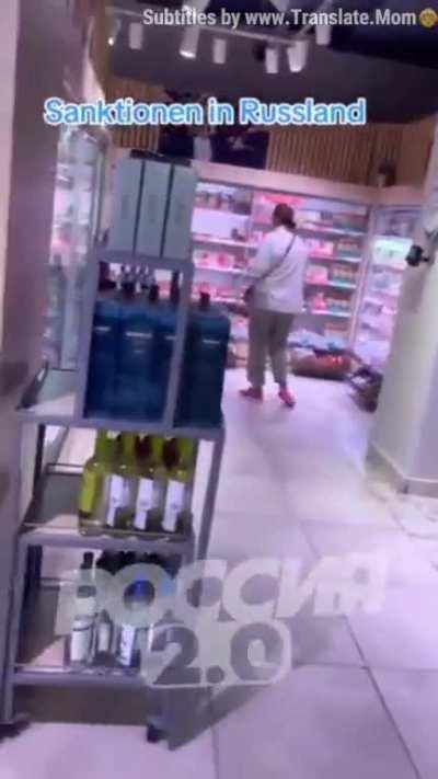 ru pov: A German walked around a Moscow supermarket showing goods on the shelves.