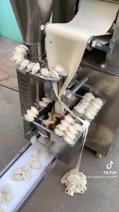 Machine making potstickers.