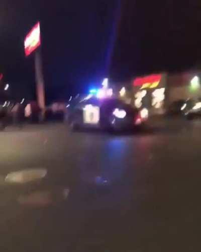 Cop driving into crowds of protestors.