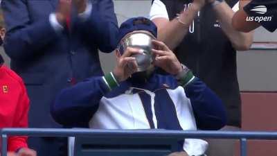 Dylan Alcott celebrates winning thr golden slam by downing a beer from his trophy