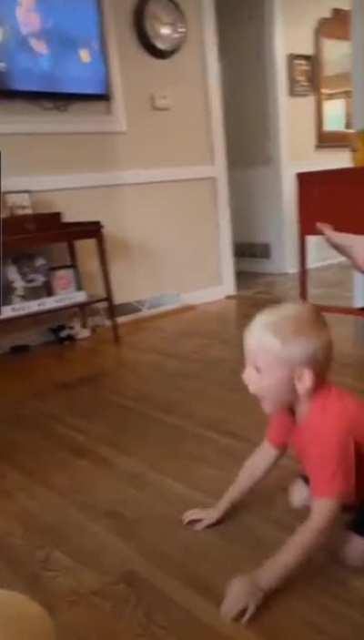 The brother is wiggling away, like he already knows.