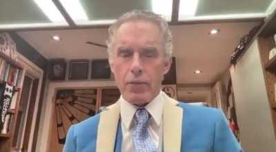 Jordan Peterson’s “twitter suit” with a matching tie that has “little Elon Musk heads”