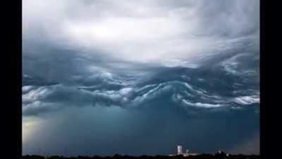 This a cloud formation called Asperitas. They form under unstable atmospheric conditions, and look like waves on a rough sea