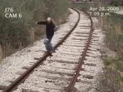 Man gets hit by a train while walking on train tracks.