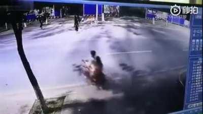 Couple on scooter disappears in the path of a speeding car