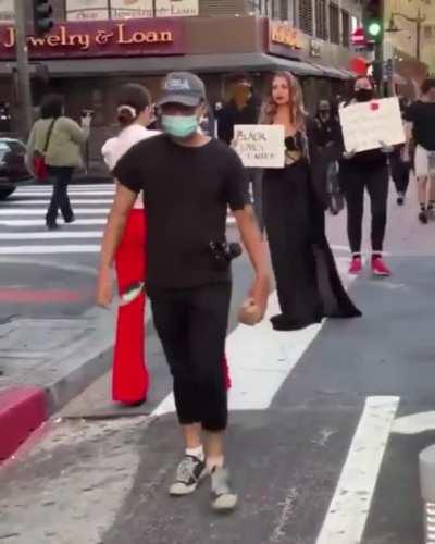 Another Influencer trying to photop with a passing BLM rally