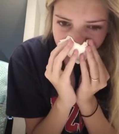 a girl blowing out a huge chunk