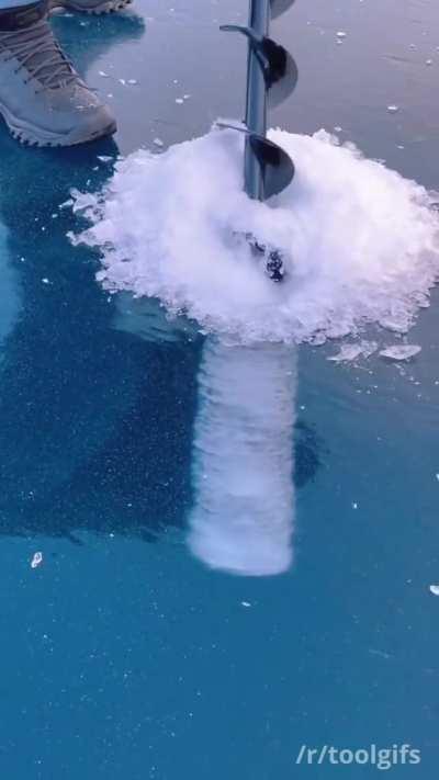 Clear view of an ice auger drilling a hole.