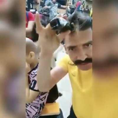 Syrian Barber comforts a girl after cutting her hair cause she had a skin disease and she thought that she became ugly, 