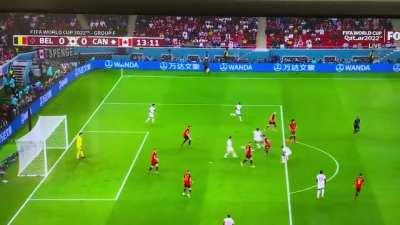 Eden Hazard (Belgium) passes the ball backwards to a Canada player. Linesman flags for offside.