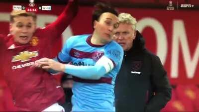 Mark Noble tackles van de Beek during a throw-in