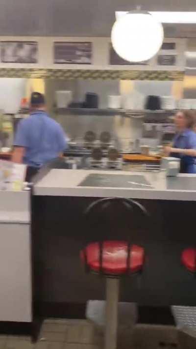 Waffle House employee casually blocks thrown chair
