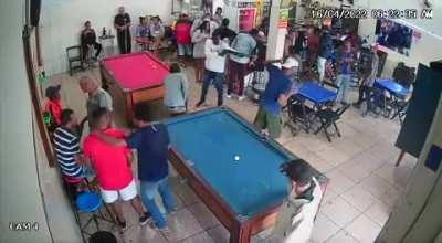 man at a bar, shoots another man in the face with a shotgun