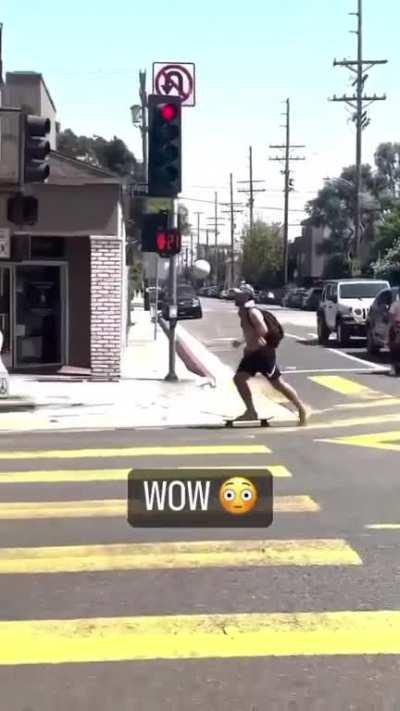 Just a guy riding a skateboard with one leg and juggling a soccer ball with the other