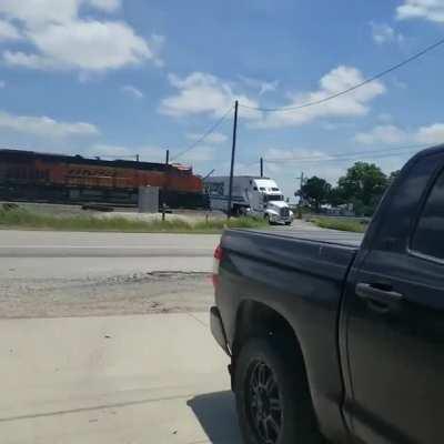 Semi high-centered on the local railroad track