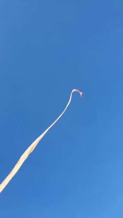 With a huge kite and strong wind