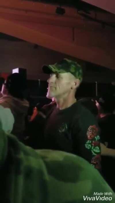 Daughter signs for her hearing impaired father at a rock concert so he can enjoy the music too