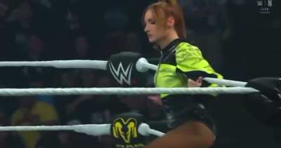 Becky taunting AJ by doing her signature sitting on the ropes.