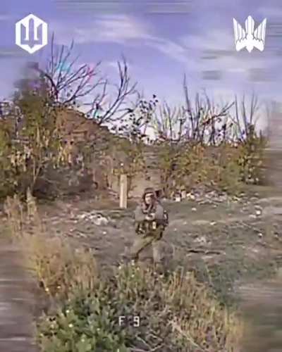 A russian soldier is fighting a drone of Madyars Birds with sticks and stones. November 2025.