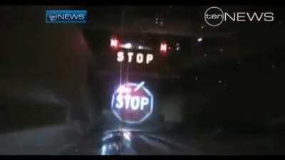 An emergency stop sign projected on a water curtain to stop tall trucks from crashing into a tunnel in Sydney, Australia.