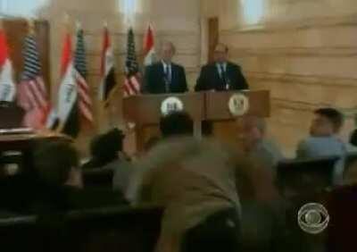 President George W. Bush getting a shoe thrown at him