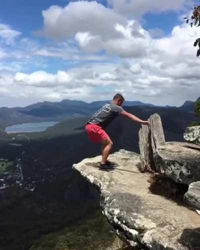 A Slow Motion Backflip of A Man Near The Edge Of a Mountain Cliff!