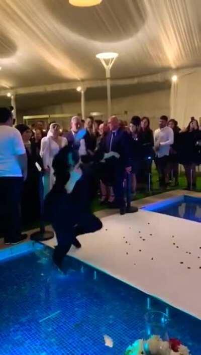 Camera girl falls into pool at wedding