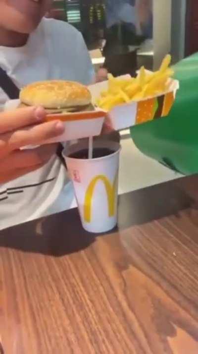 To show how youâre supposed to handle and eat the McDonaldâs combo 