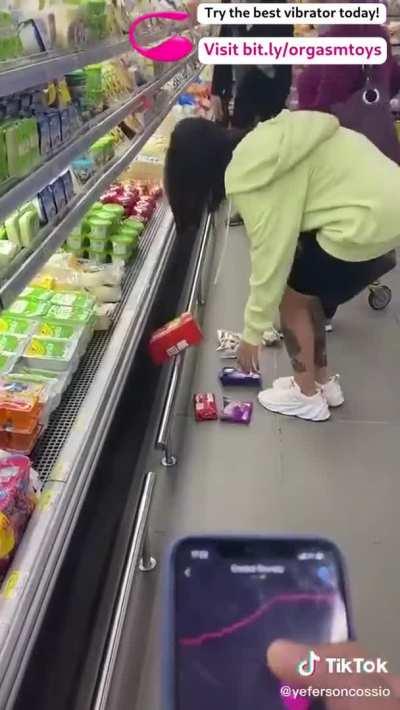 Controlling her vibrator at a shop