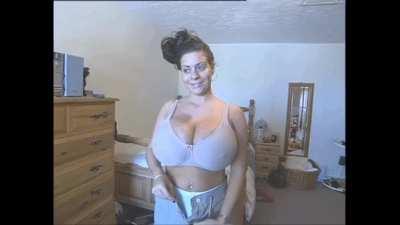 The smirk of a lady who knows only an industrial strenght bra would be up to the task of containing those massive burgeoning knockers