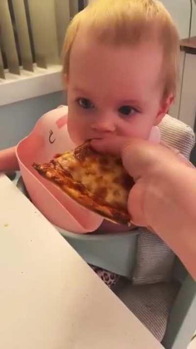 baby's first bite of pizza