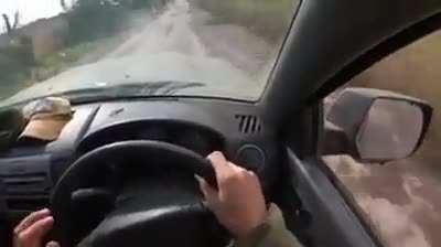 Ukrainian soldiers come under fire from a sniper whose bullet hits the driver. His bulletproof vest saved him from serious injury.