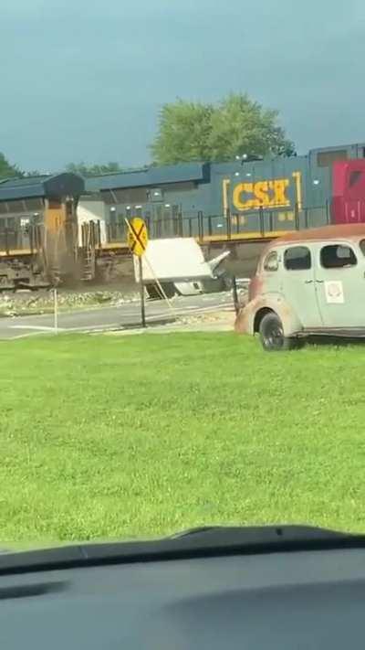 Semi on railroad tracks gets hit by train