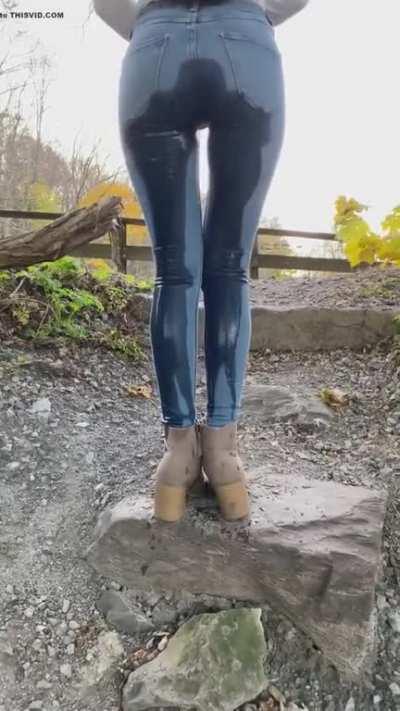 Desperate girl pees her jeans on road side.