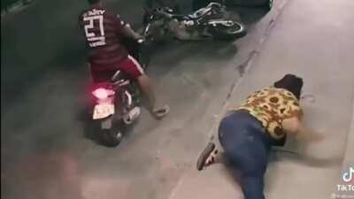 Morbidly obese woman tries sit on the back of a motorcycle.