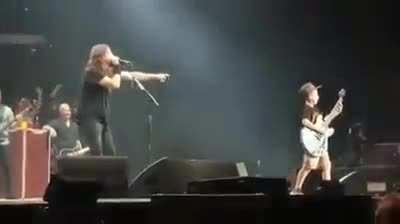 10 year old Collier Cash Rule gets on stage during a Foo Fighters concert