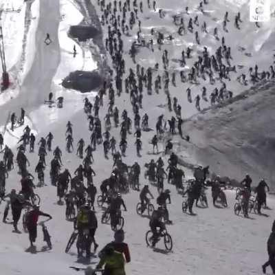 Hundreds of cyclist hurtle down an icy cliff and crash into one another at the Mountain of Hell bike race