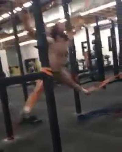 Guy in gym exercising with elastic bands
