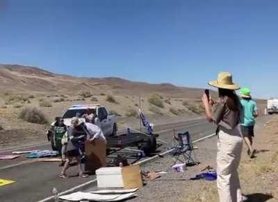 Nevada Ranger drives through Climate Change Protestor blockade on the road to Burning Man. Officer then pulls gun and violently arrests protestors