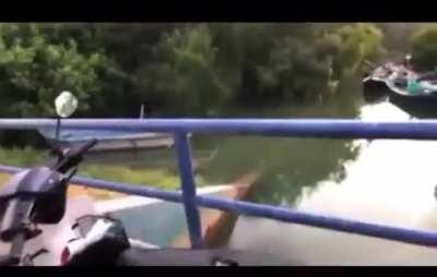 Singing while sitting on the edge of a bridge fence