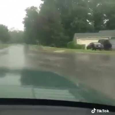 Splashing people in the rain with their truck