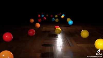 Each ball is swinging slightly slower than the one in front of it. 3d render.