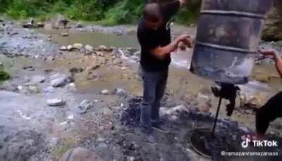 This guy cooking a whole lamb with a special technique and turning it in to a charcoal.