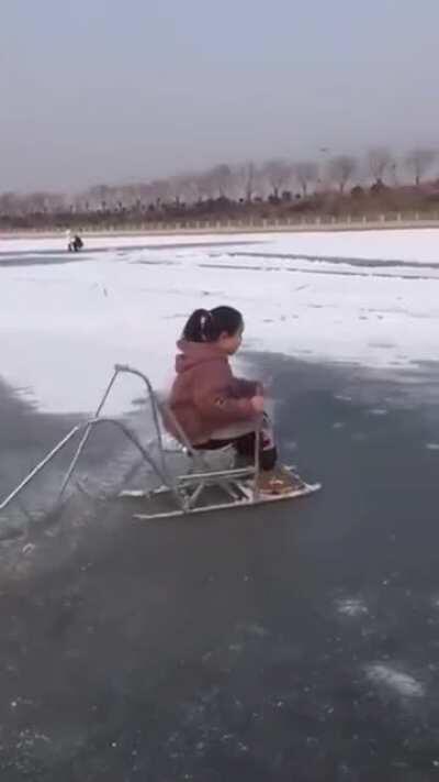 This sled has hand levers attached to metal rods at the rear that allow you to propel yourself along on ice and snow