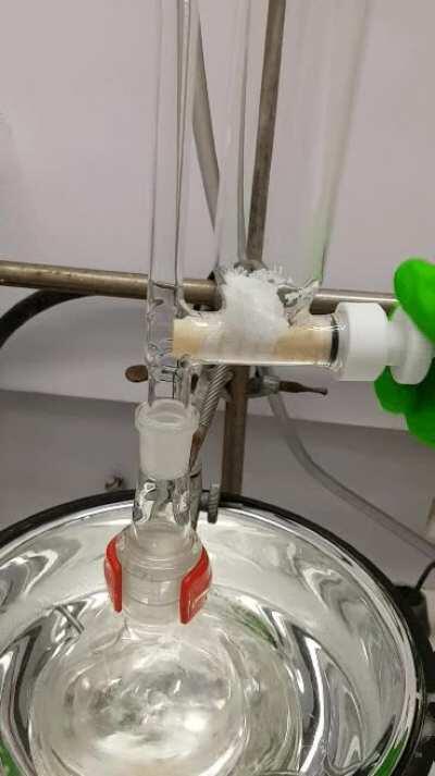 Addition funnel for adding solids slowly under inert atmosphere.