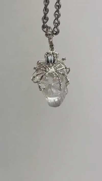 My latest spider pendant wrapped around a crystal skull