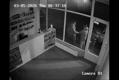 Angry woman headbutts shop window