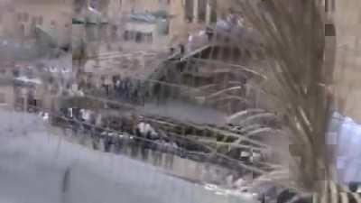 Israeli settler tries to take down Palestinian flag but gets stuck in barbed wire.