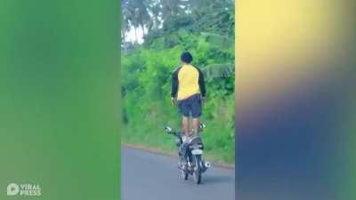 Daredevil Motorcycle Rider Stands On Seat